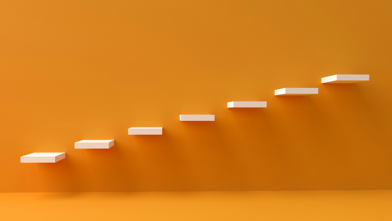 Un escalier de marches blanches ascendantes sur fond orange
